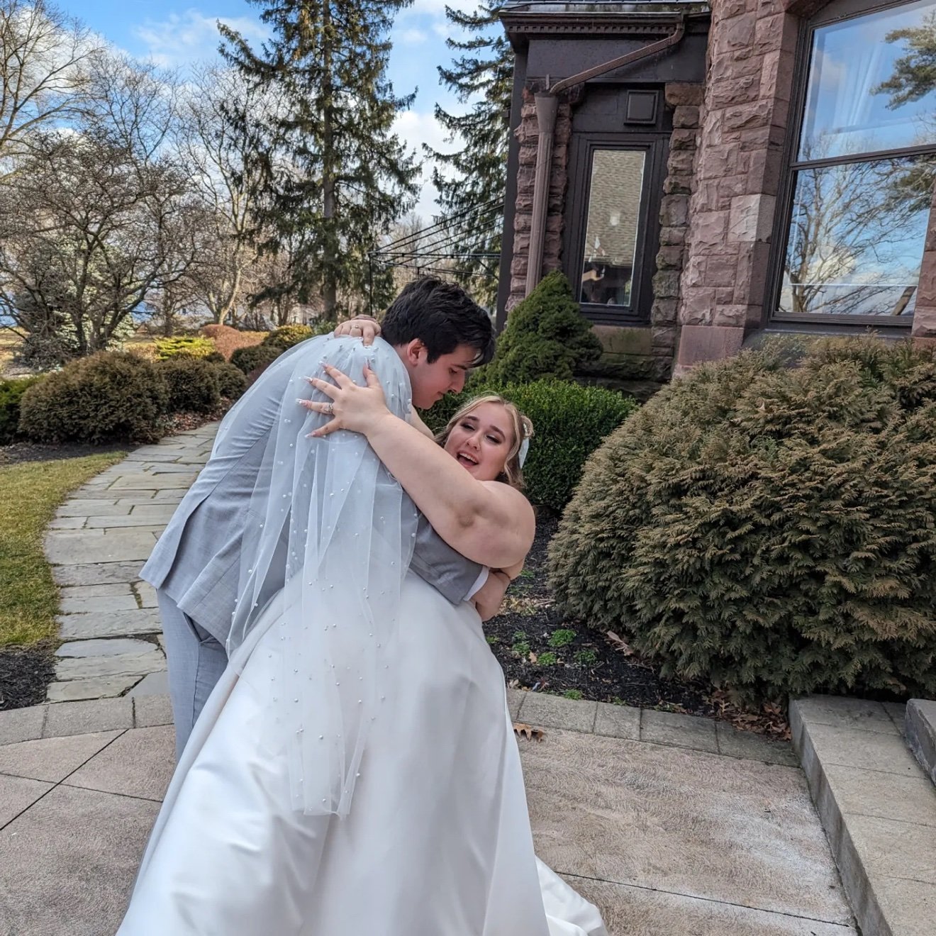 Axel and Savannah hugging outside on their wedding day