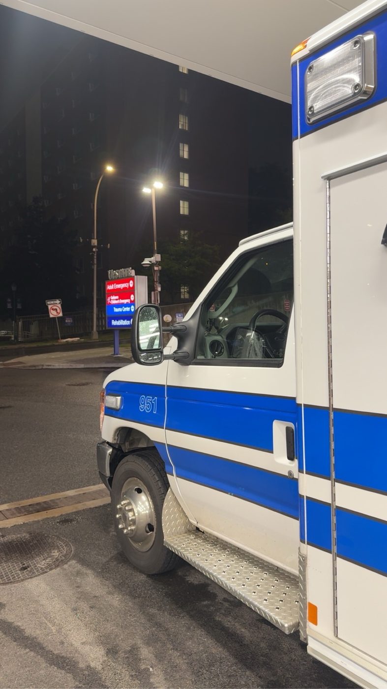 Ambulance 951 parked outside the hospital emergency entrance at night