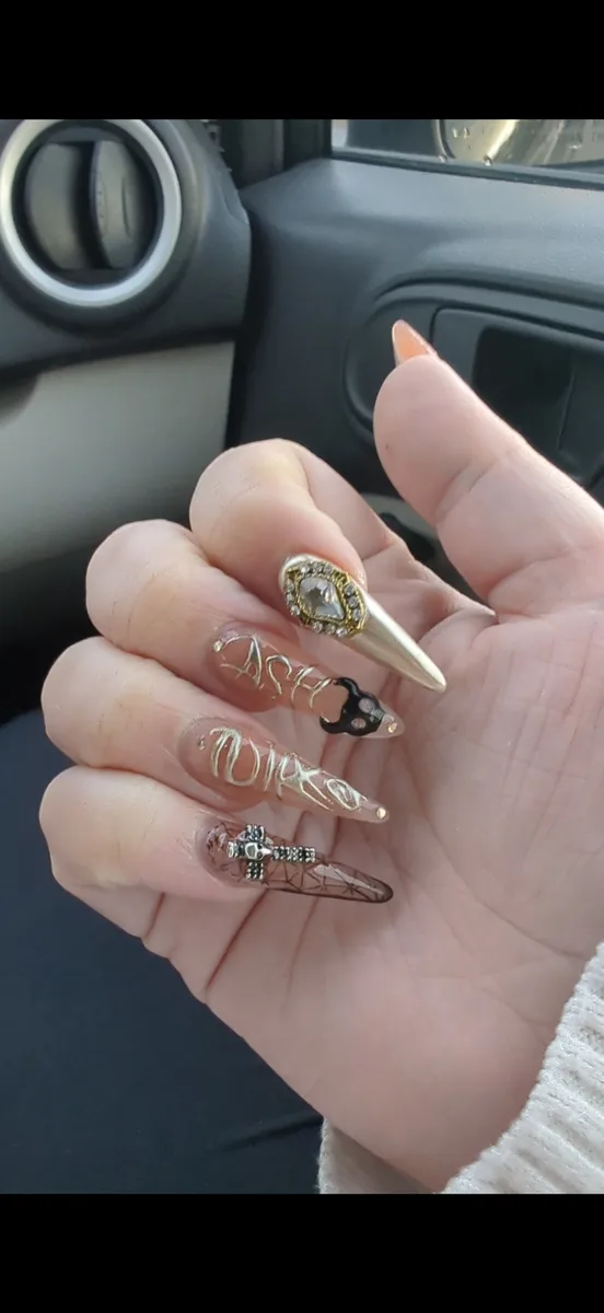 Gold chrome stiletto nails with charms