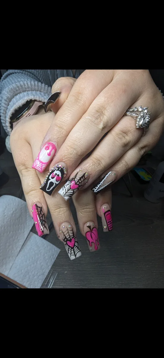 Pink and black Halloween nail art with a ghost, spiderwebs and a pumpkin