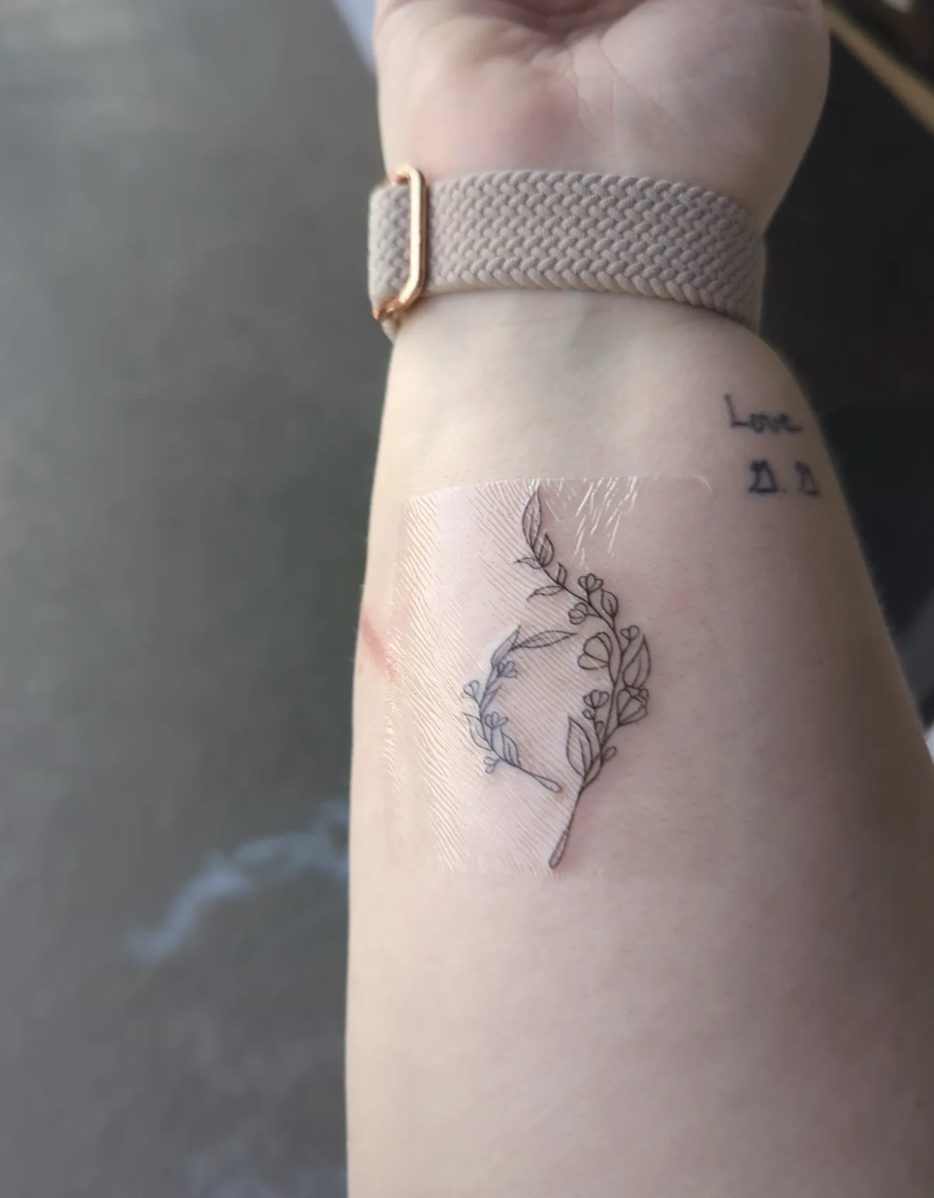 Fine line floral wrist tattoo